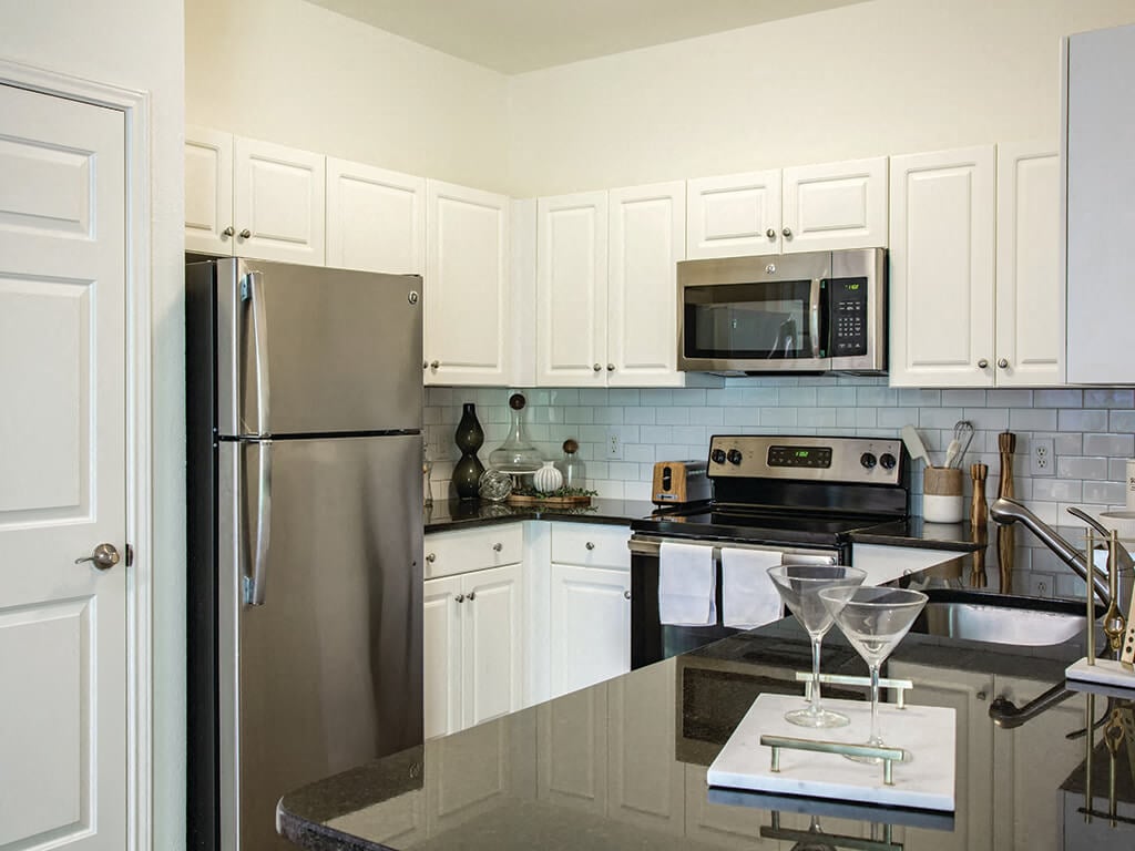 A kitchen with dark countertops at the Heritage on the Merrimack Apartments in Bedford, New Hampshire.